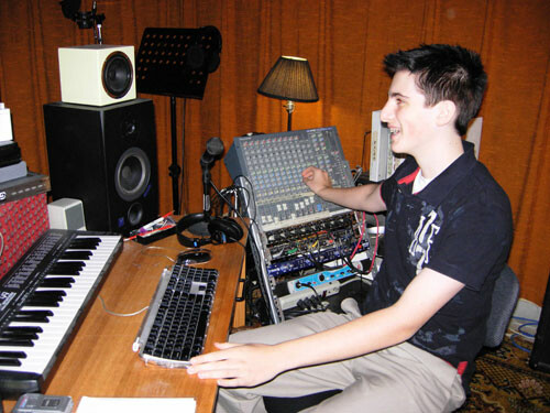 Picture of a person sitting at a soundboard